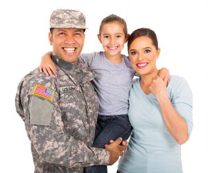 happy young military family of three on white background